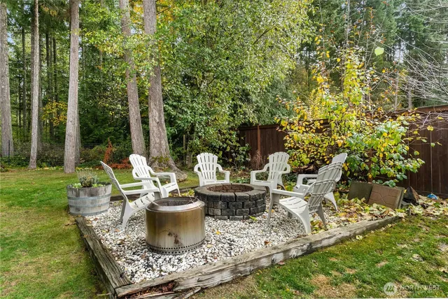 a view of a backyard with sitting area and garden