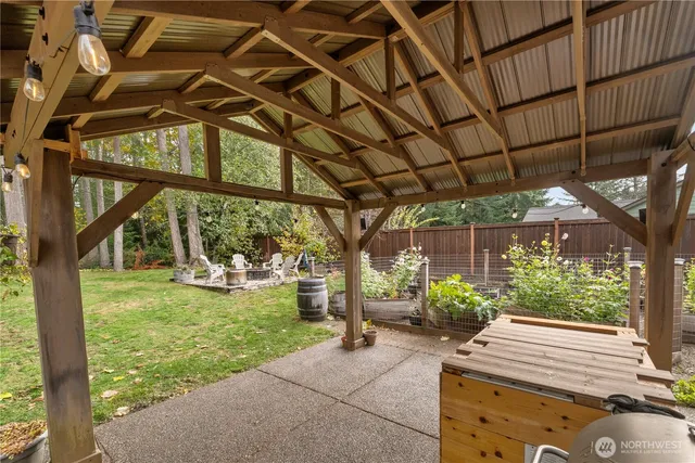 a view of a chair and table in backyard of the house