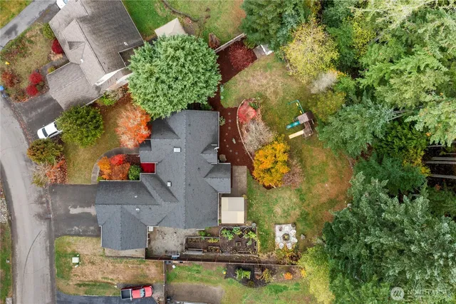 an aerial view of a house with a yard