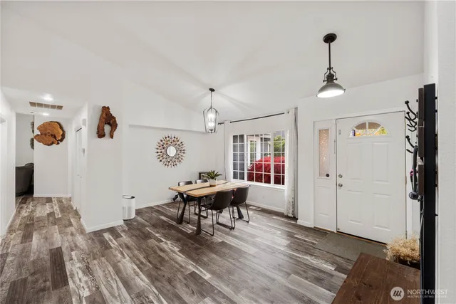 a view of a livingroom with furniture wooden floor and windows