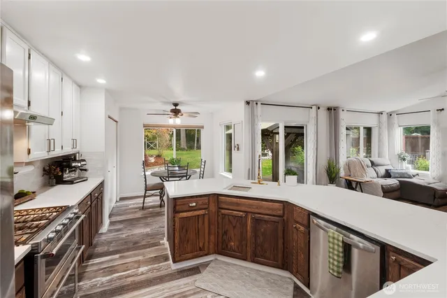 a large kitchen with a large window and stainless steel appliances