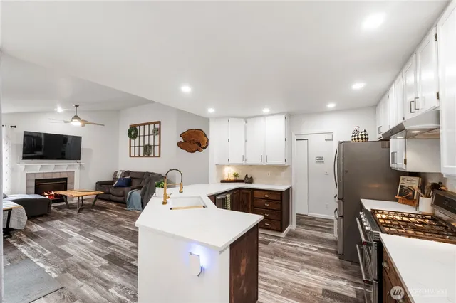 a large kitchen with a table chairs refrigerator and a sink