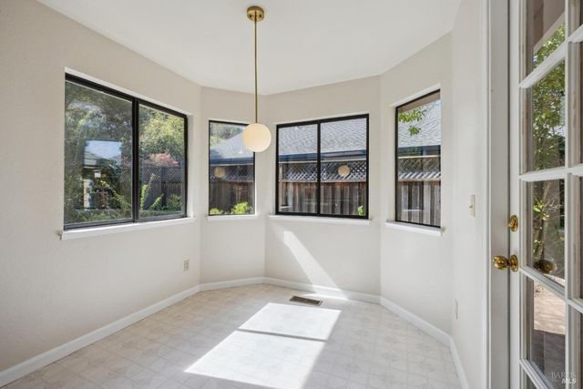 an empty room with windows and bathroom view