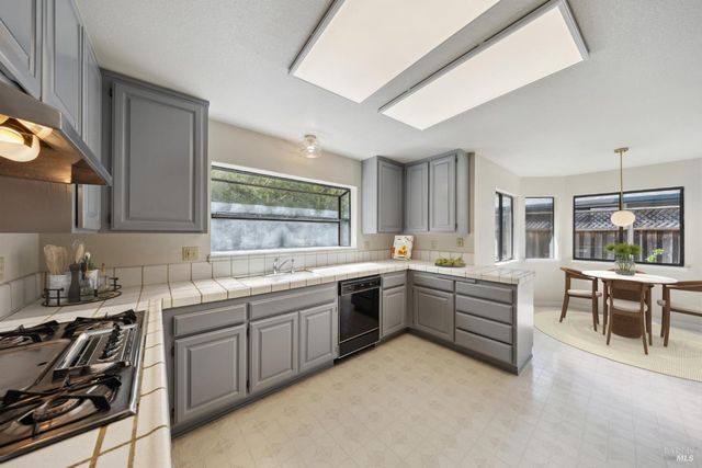 a large kitchen with a large window and counter space