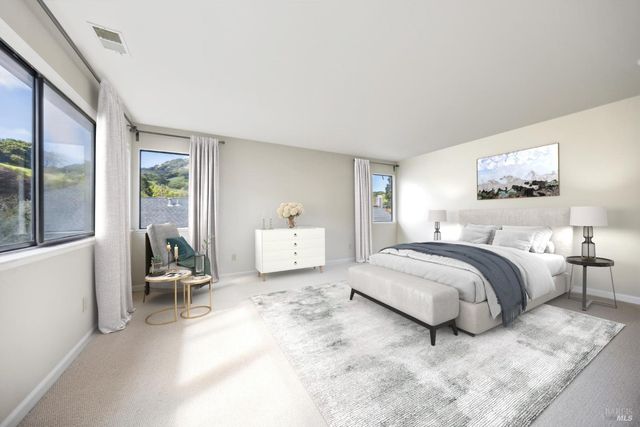 a spacious bedroom with a bed and a couch