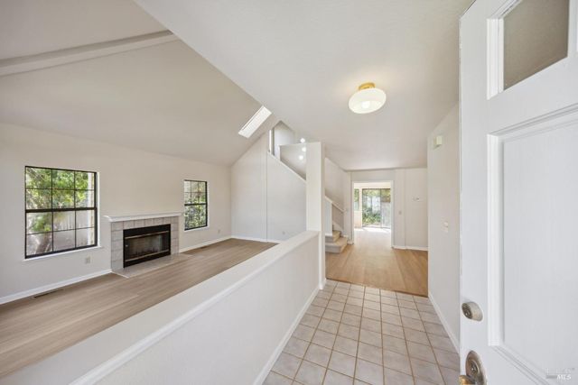 a view of empty room with wooden floor and fireplace