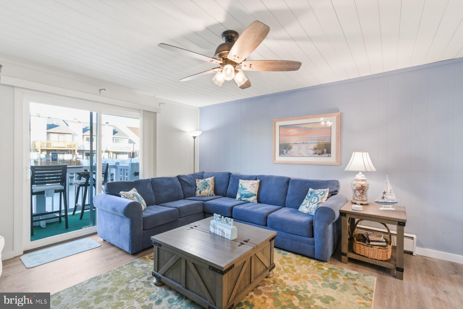 722 Mooring Road, Unit A104 Ocean City, MD 21842 - Photo 12 of 33 a living room with furniture a ceiling fan and a window