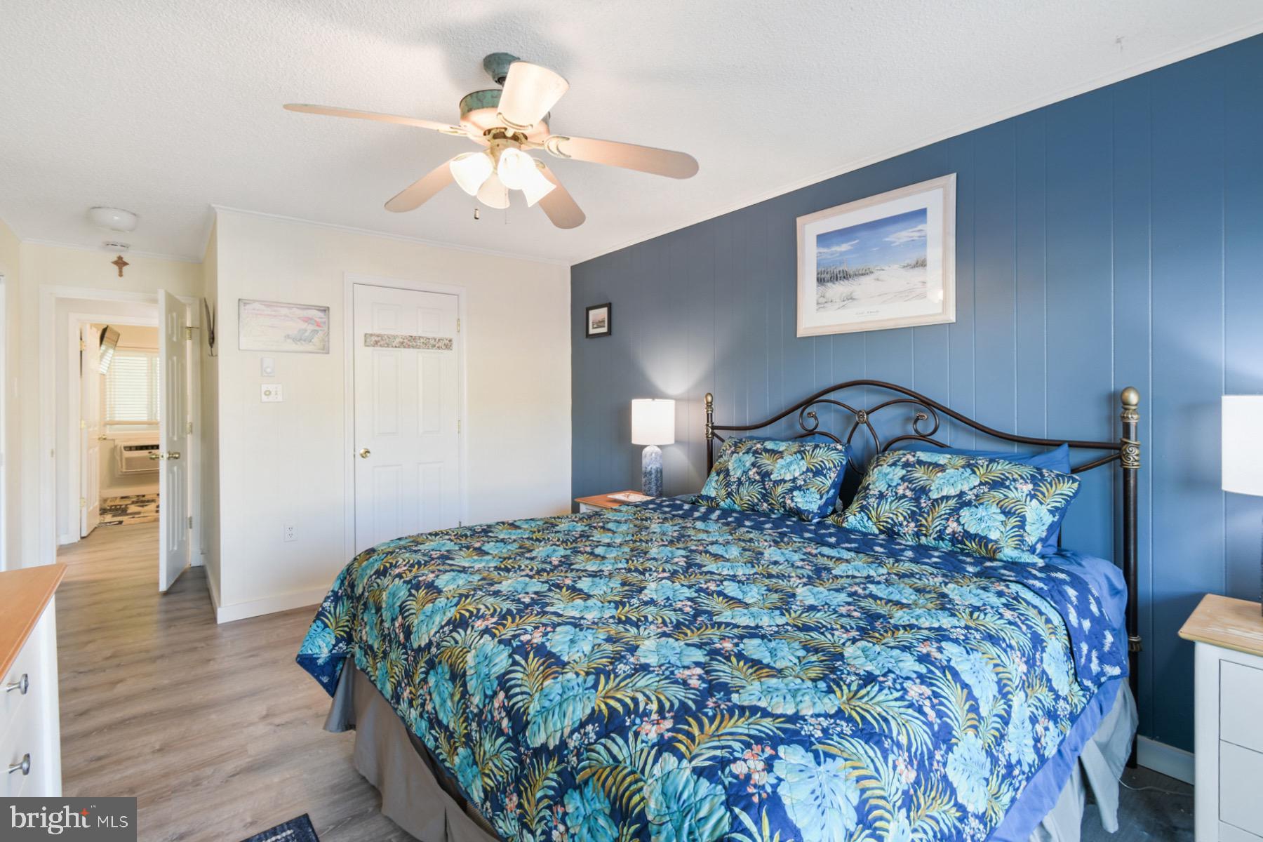 722 Mooring Road, Unit A104 Ocean City, MD 21842 - Photo 17 of 33 a bedroom with a bed and a chandelier