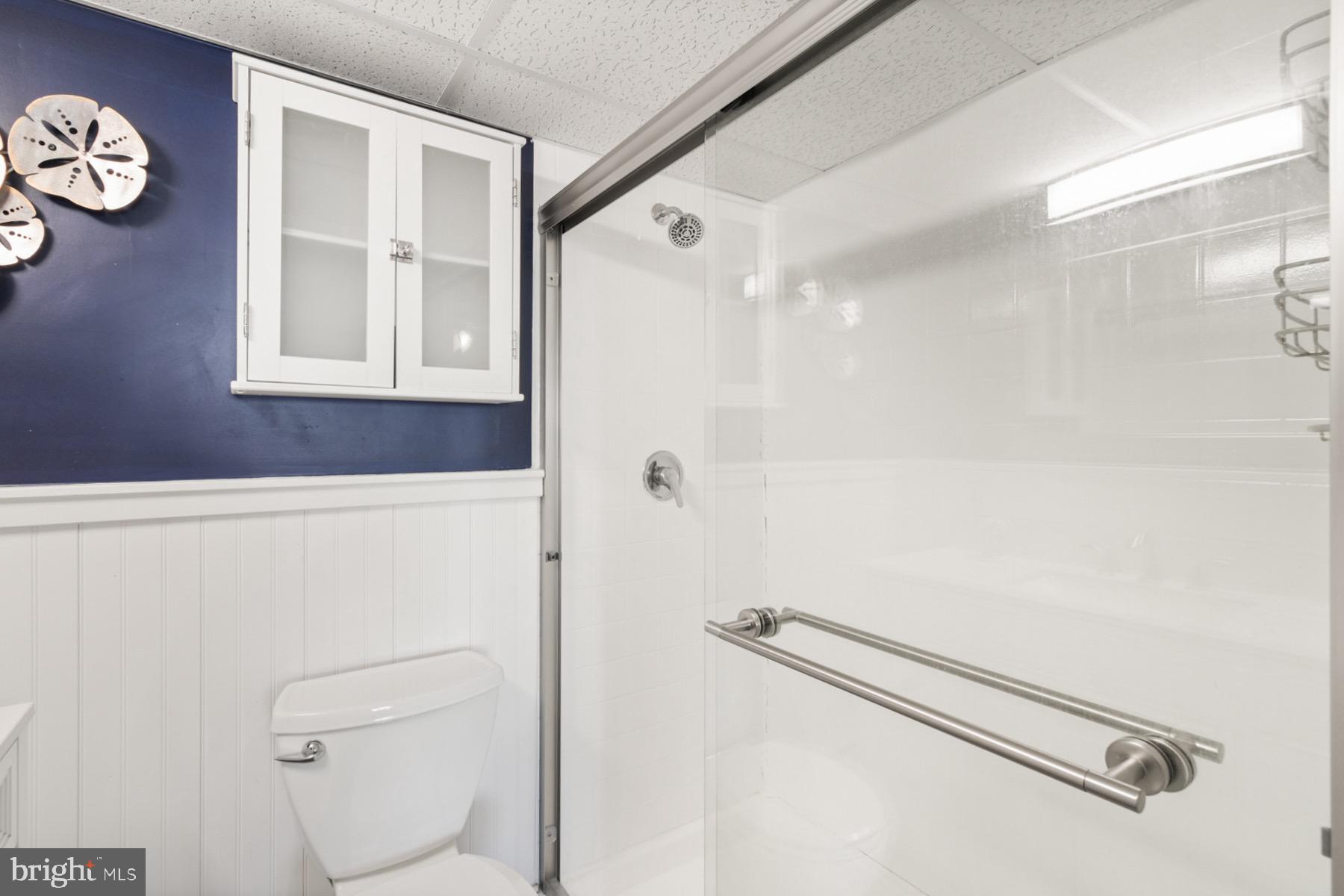 722 Mooring Road, Unit A104 Ocean City, MD 21842 - Photo 20 of 33 a bathroom with a shower a toilet and a window