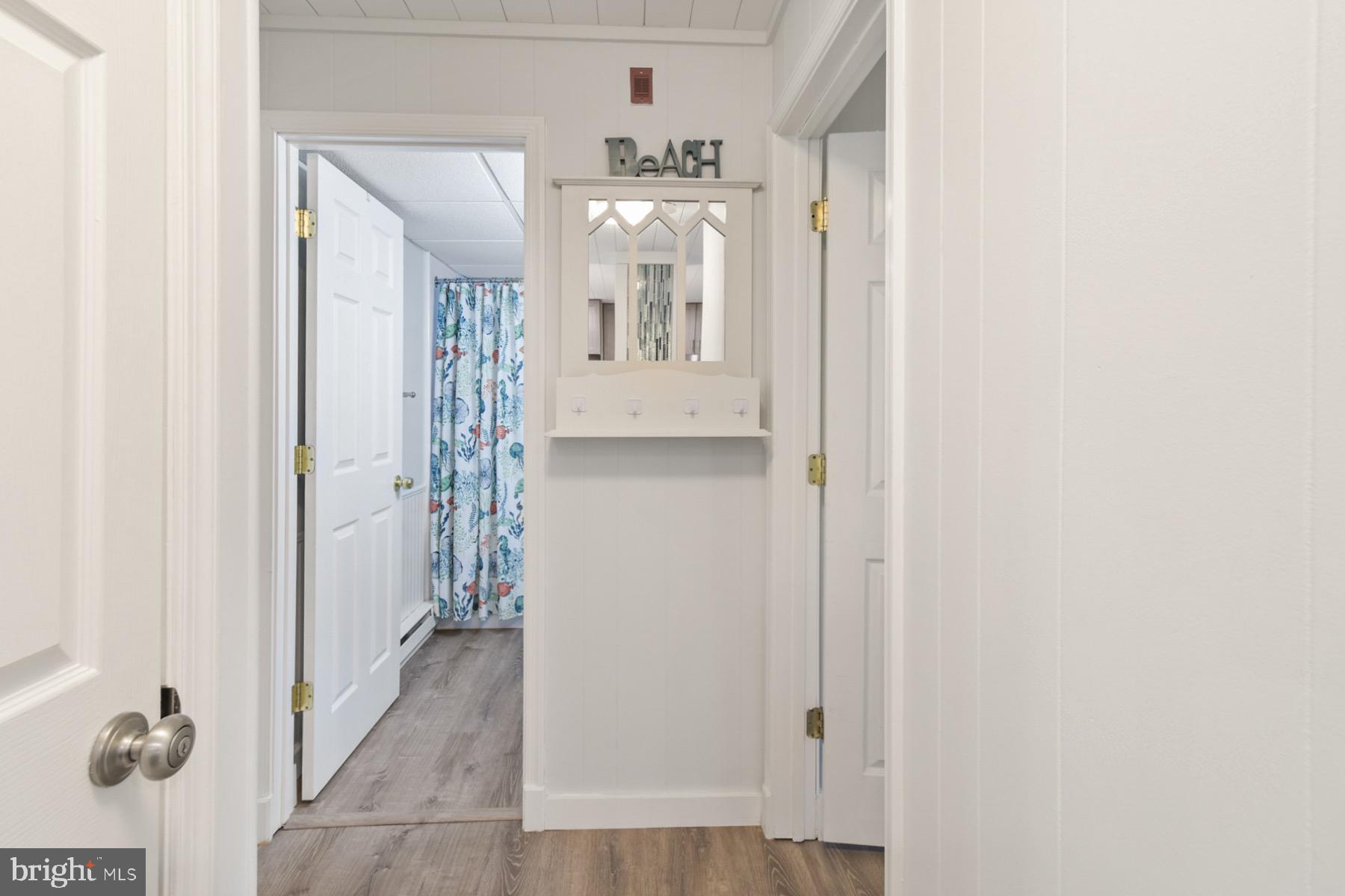 722 Mooring Road, Unit A104 Ocean City, MD 21842 - Photo 23 of 33 a view of a hallway with wooden floor