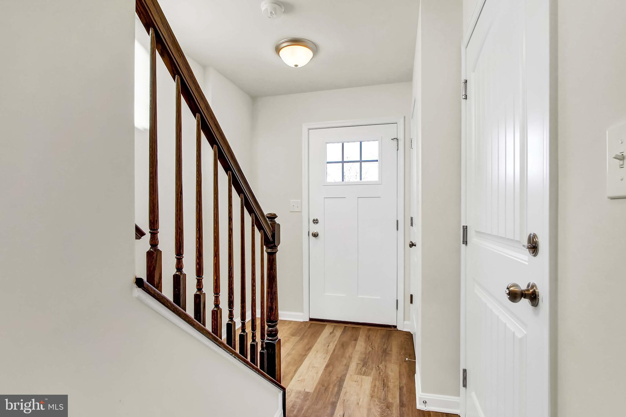 51 Overlook Dr., Unit I Hanover, PA 17331 - Photo 1 of 14 a view of a hallway with wooden floor and staircase