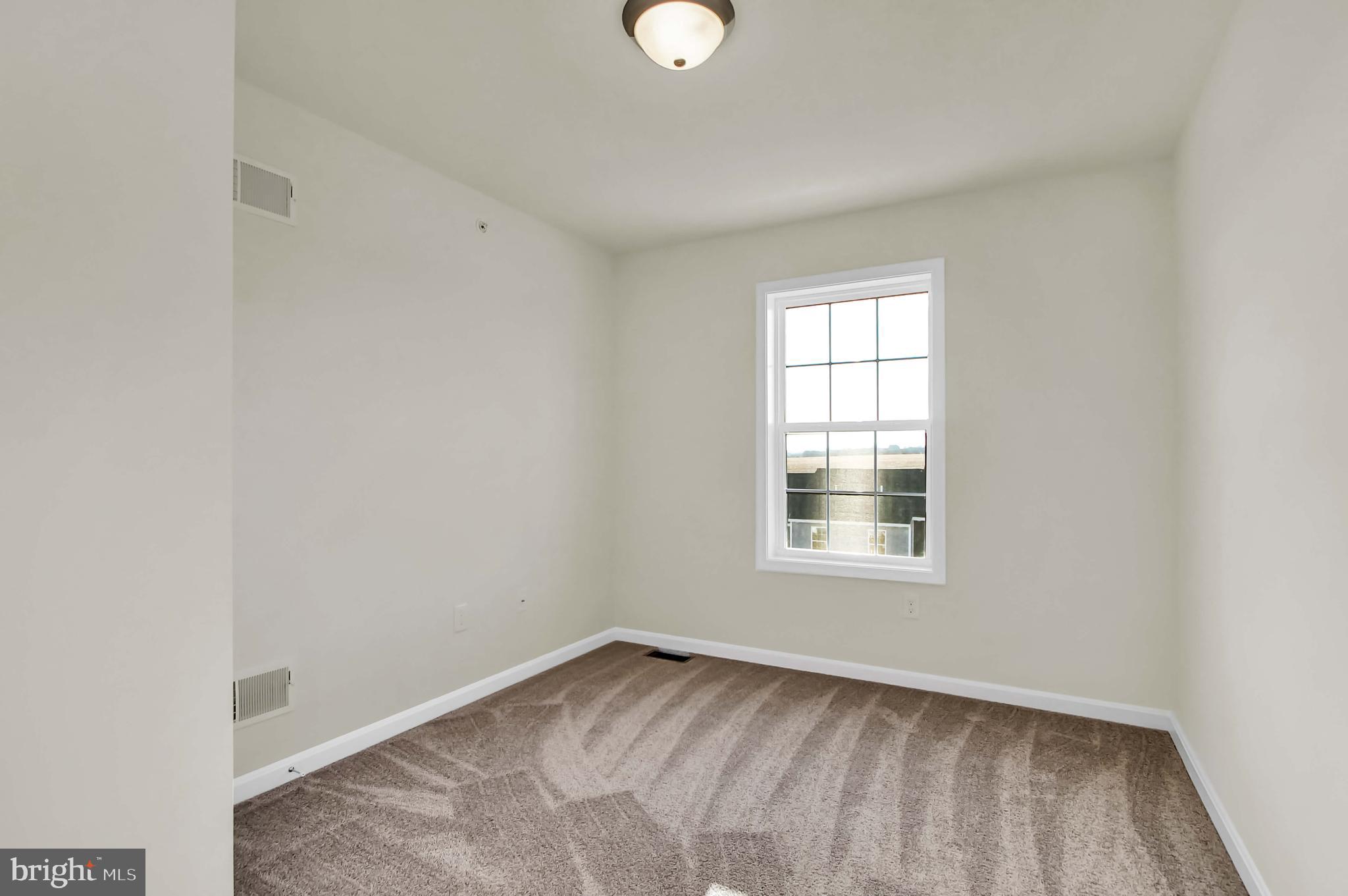 51 Overlook Dr., Unit I Hanover, PA 17331 - Photo 13 of 14 an empty room with wooden floor and windows