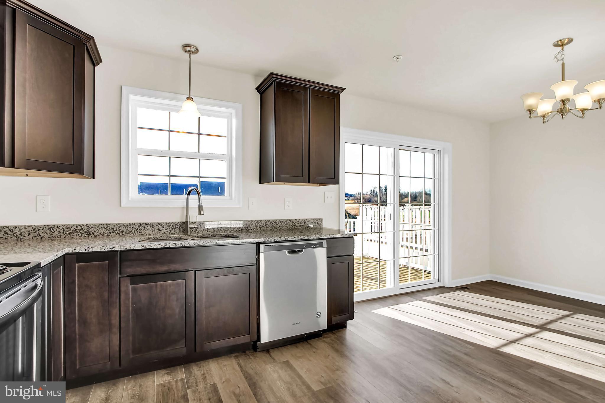 51 Overlook Dr., Unit I Hanover, PA 17331 - Photo 4 of 14 a kitchen with stainless steel appliances granite countertop a sink dishwasher a stove and a refrigerator with wooden floor