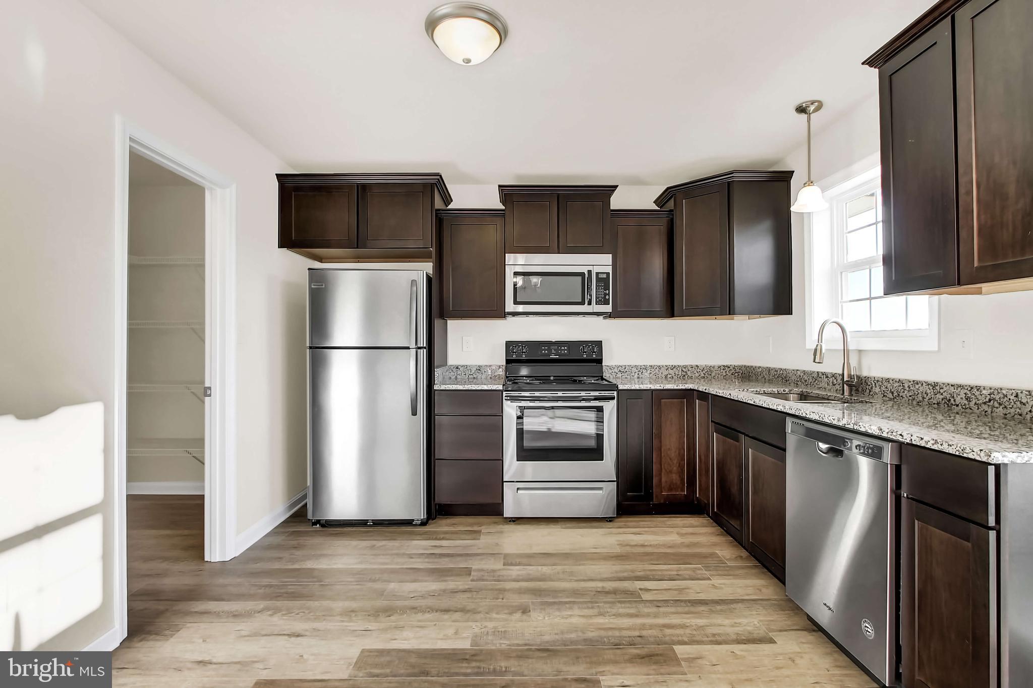 51 Overlook Dr., Unit I Hanover, PA 17331 - Photo 6 of 14 a kitchen with stainless steel appliances granite countertop a refrigerator stove and oven