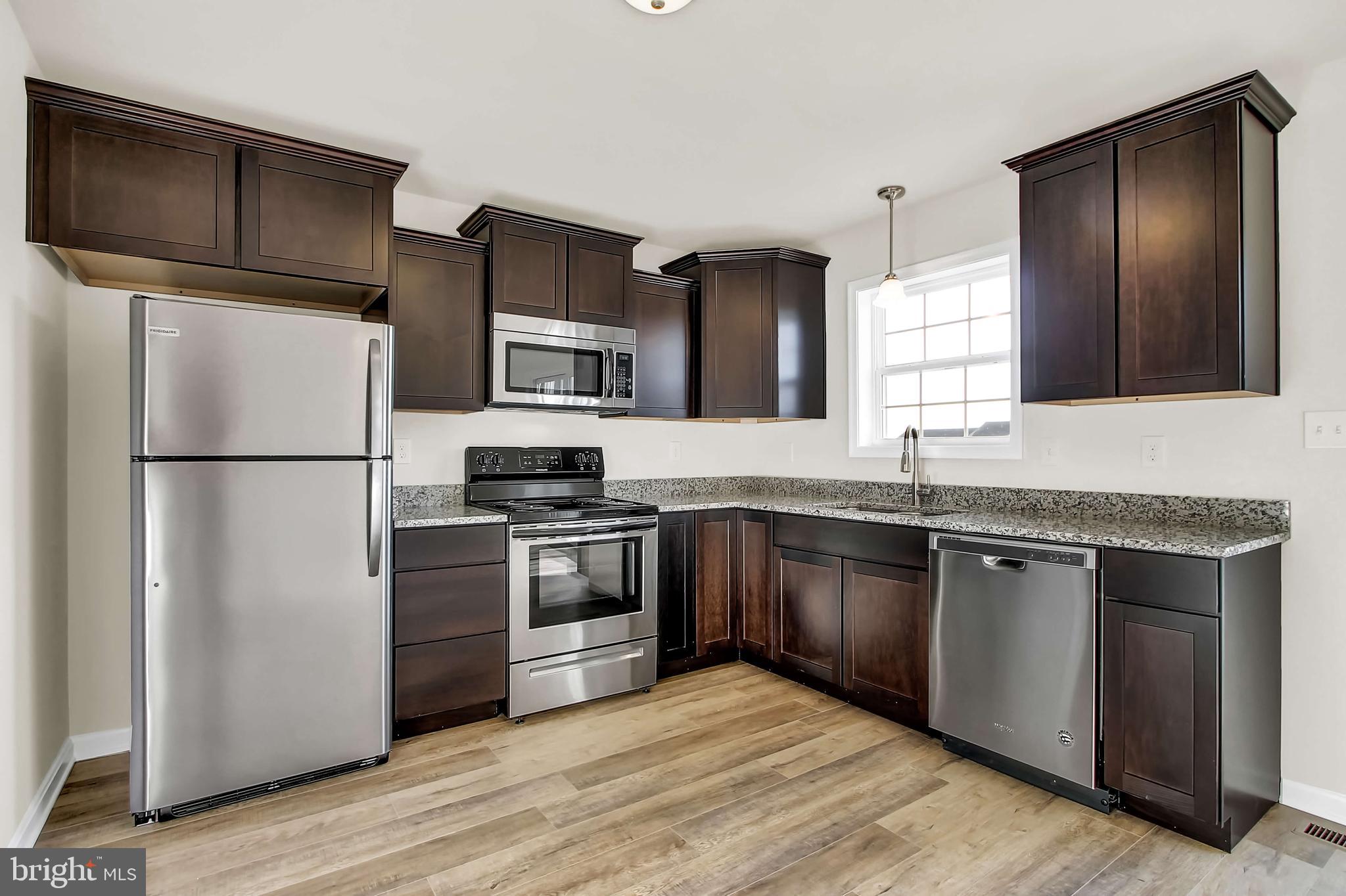 51 Overlook Dr., Unit I Hanover, PA 17331 - Photo 8 of 14 a kitchen with stainless steel appliances granite countertop a refrigerator stove a sink and dishwasher
