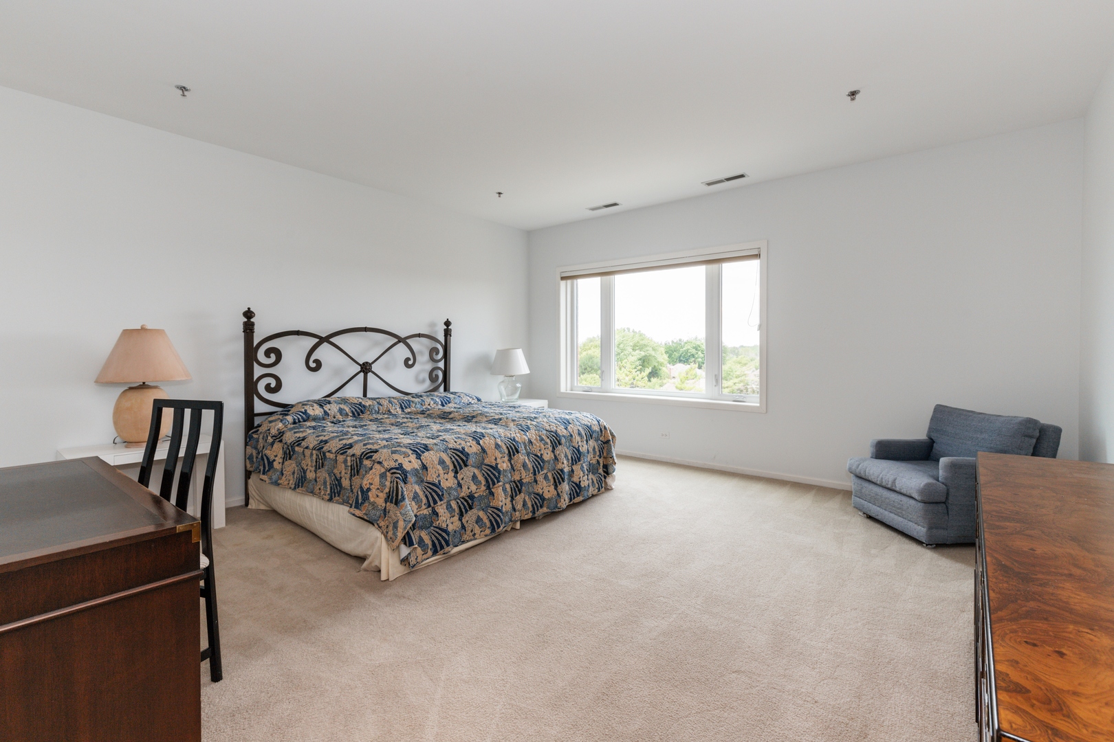 211 Rivershire Lane, Unit 501 Lincolnshire, IL 60069 - Photo 7 of 17 a bedroom with a bed and window