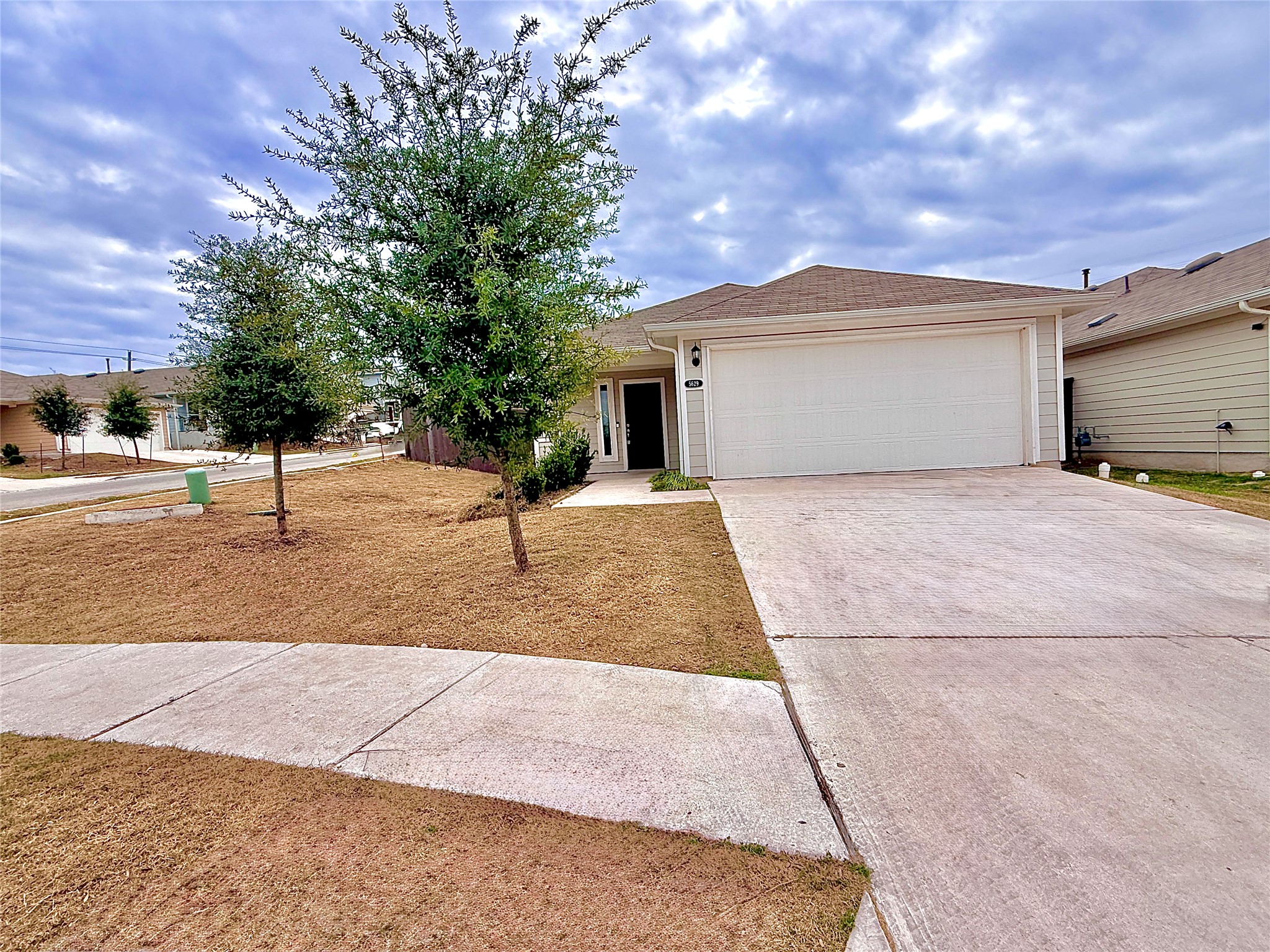 Ranch-style home with concrete driveway and a garage