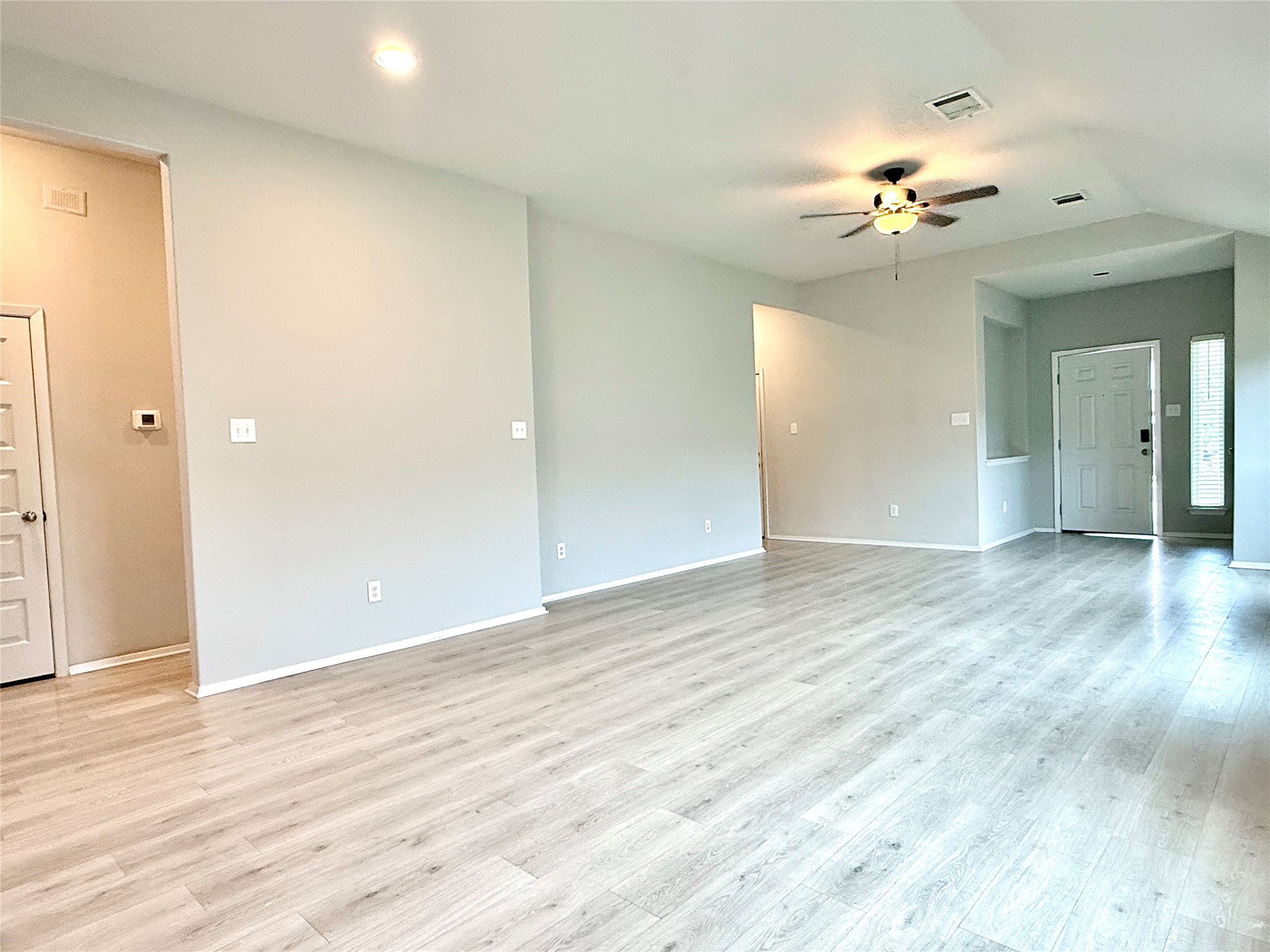 5629 Corso Court Austin, TX 78747 - Photo 5 of 23 Spare room featuring a ceiling fan, light wood-style flooring, and vaulted ceiling