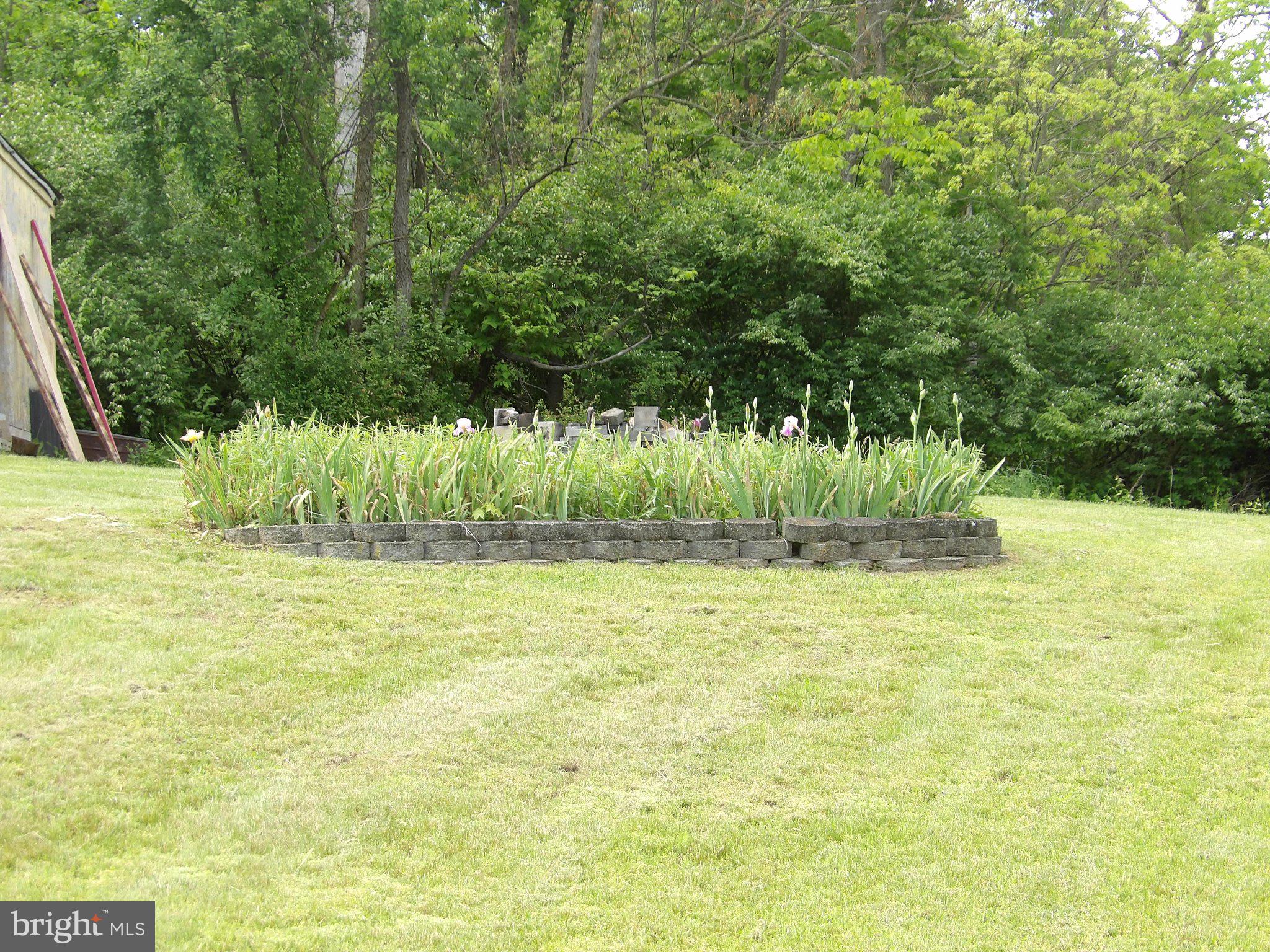 1045 Lockport Road Lewistown, PA 17044 - Photo 33 of 51 Lush garden oasis in serene landscape.