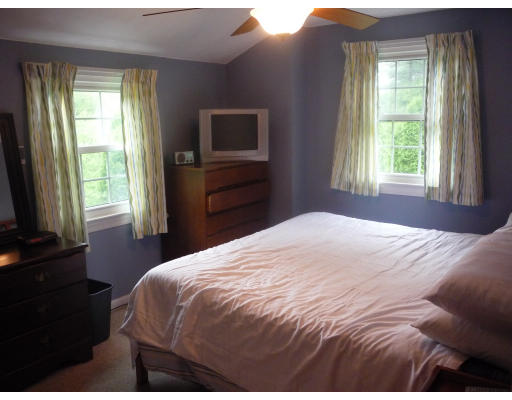 427 Treble Cove Road Billerica, MA 01862 - Photo 15 of 23 a bedroom with a bed and a flat tv screen on dresser