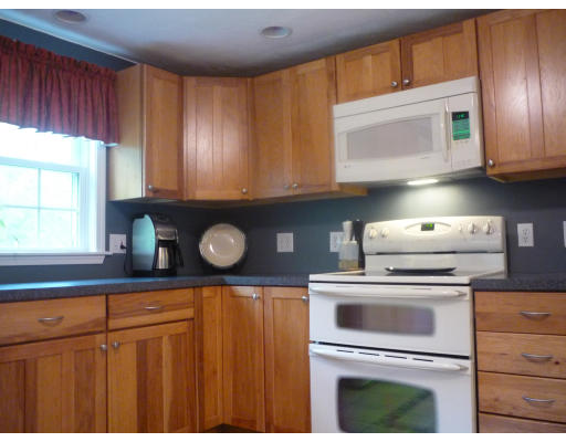427 Treble Cove Road Billerica, MA 01862 - Photo 2 of 23 a kitchen with granite countertop cabinets stainless steel appliances and a window