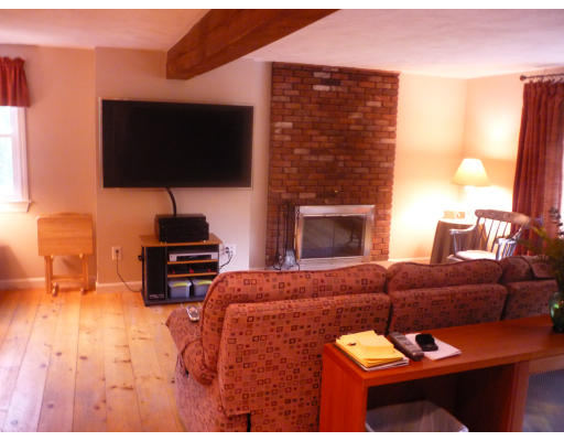 427 Treble Cove Road Billerica, MA 01862 - Photo 8 of 23 a living room with furniture a flat screen tv and a fireplace