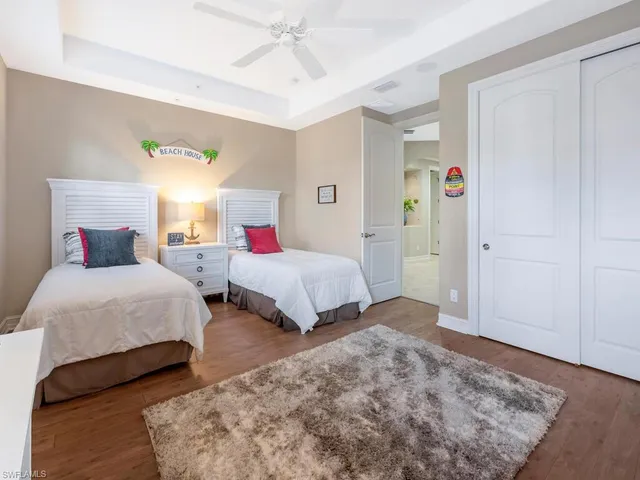 a bedroom with two beds and a window