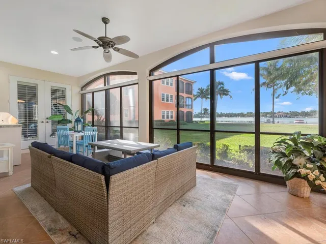 a dining room with furniture and a large window
