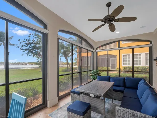 a living room with furniture and a floor to ceiling window