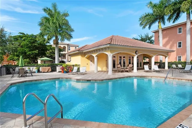 a view of a white house with a swimming pool