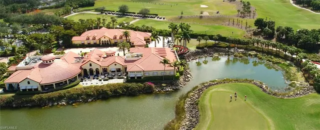 an aerial view of a house with swimming pool and outdoor seating