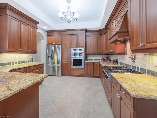 a kitchen with stainless steel appliances granite countertop a stove top oven a sink and dishwasher