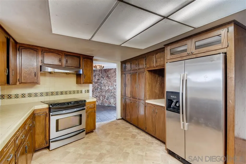1764 Navaja Road El Cajon, CA 92020 - Photo 11 of 24 a kitchen with a stove top oven and refrigerator