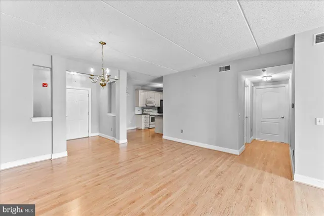 a view of empty room with wooden floor
