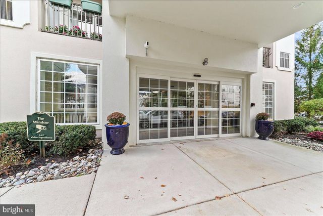 a front view of a building with a garden