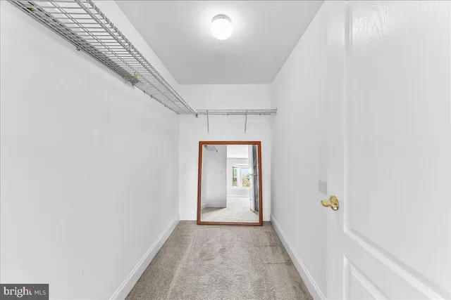 a view of a hallway view with wooden floor and staircase