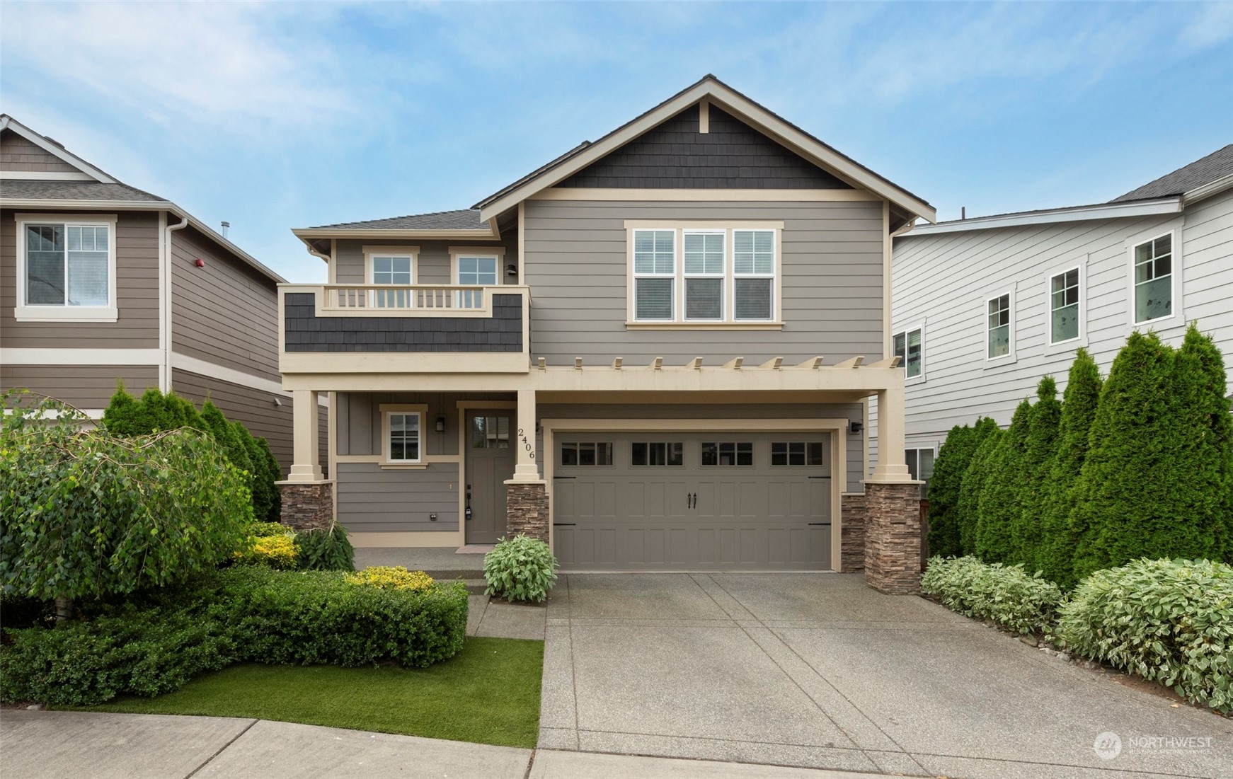 a front view of a house with a yard and garage