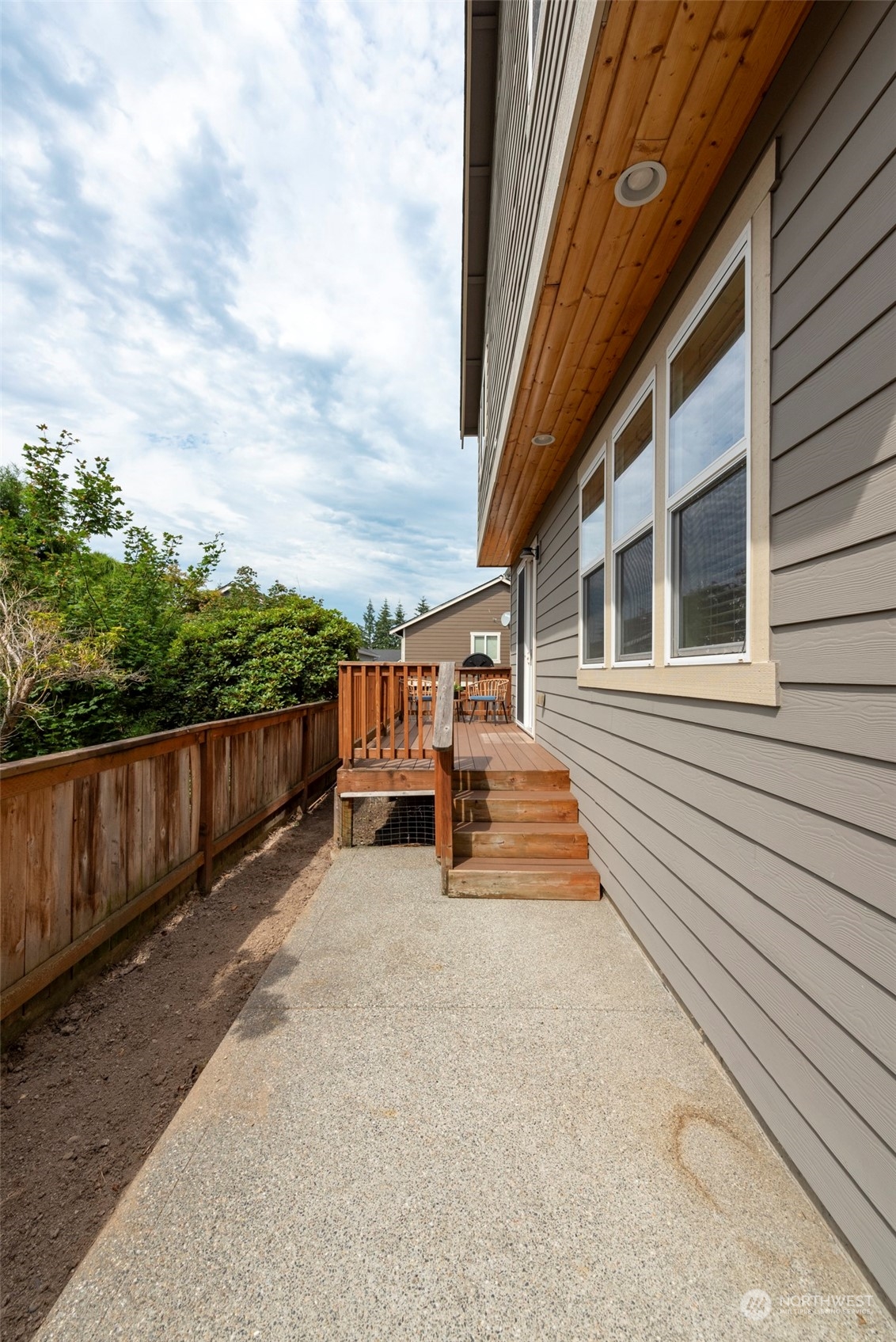 2406 196th Place Southeast Bothell, WA 98012 - Photo 28 of 30 a view of a patio with table and chairs with wooden floor and fence