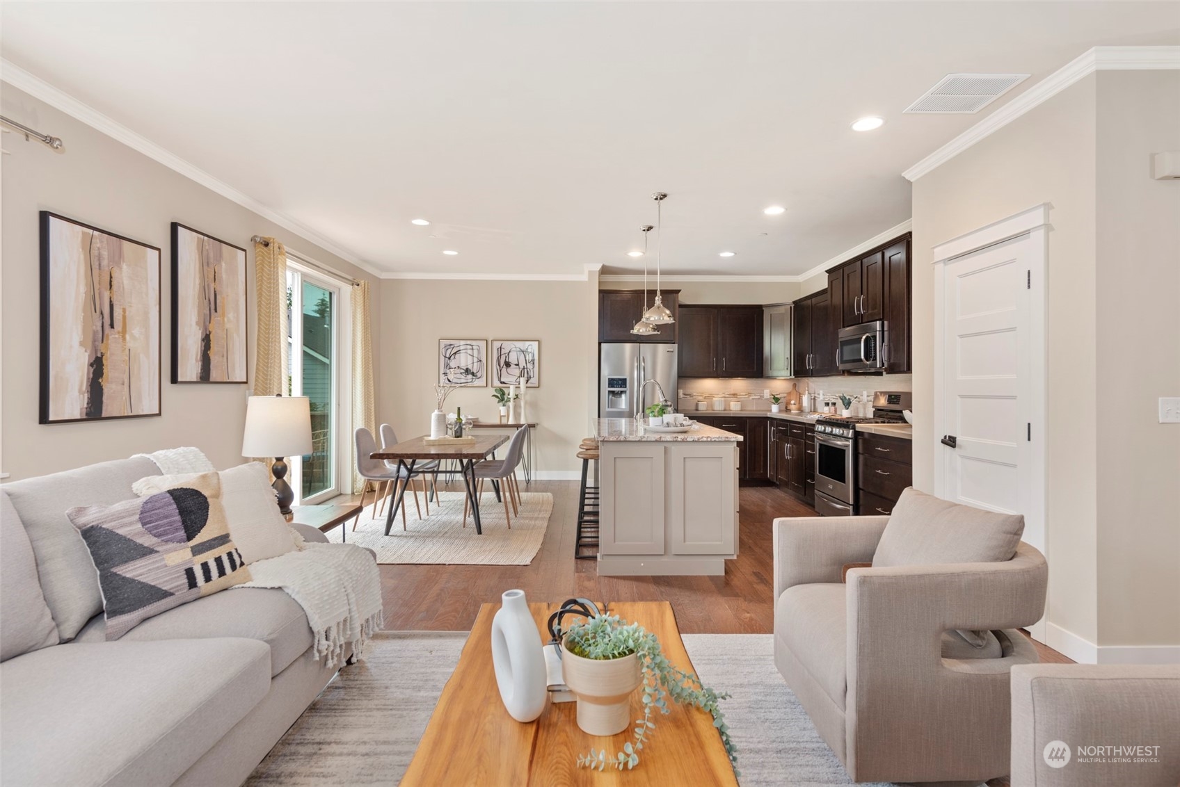 2406 196th Place Southeast Bothell, WA 98012 - Photo 7 of 30 a living room with stainless steel appliances kitchen island granite countertop a couch and white cabinets