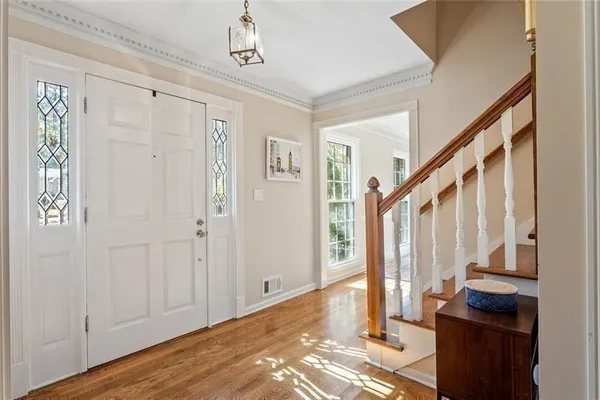 a bedroom with bed and a chandelier