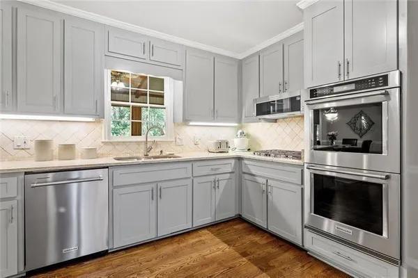a bathroom with a granite countertop double vanity sink a vanity and a large mirror