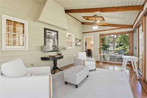 a bedroom with a large bed and a flat tv screen on dresser