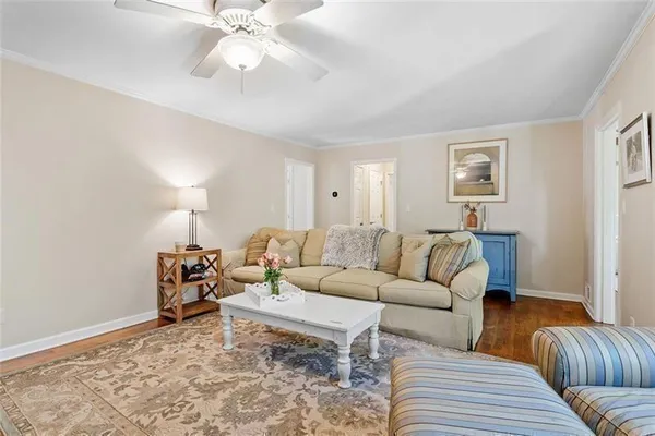 a bathroom with a granite countertop sink and a refrigerator