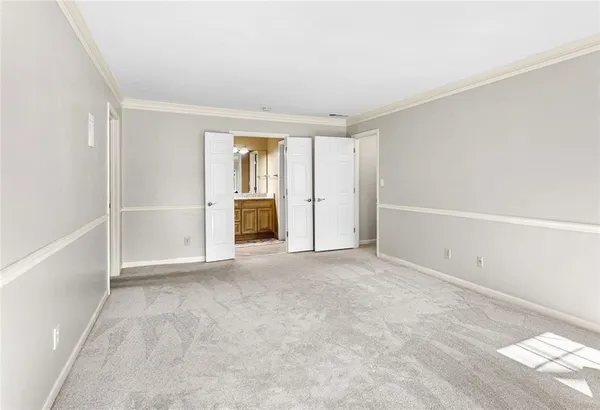 a view of a house with a yard next to a lake