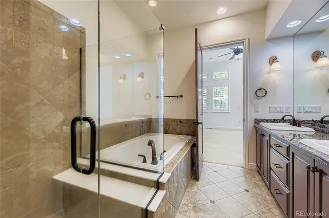 a bathroom with a tub a sink and a mirror