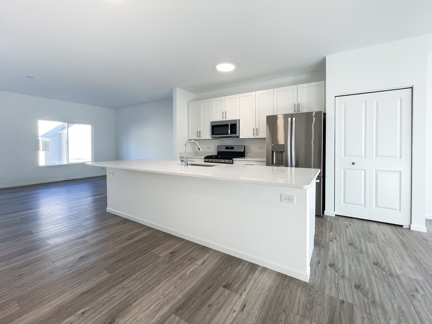 235 Regency Court, Unit B Wauconda, IL 60084 - Photo 2 of 23 a kitchen with stainless steel appliances a refrigerator sink and microwave