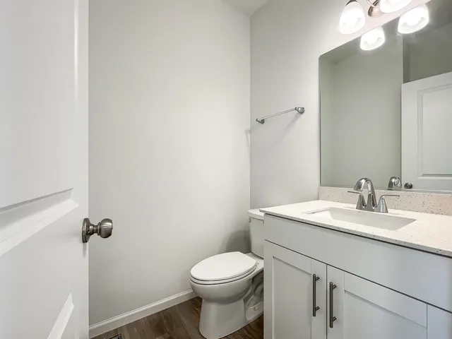 a bathroom with a sink a toilet and vanity