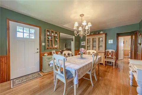 a view of a dining room with furniture wooden floor and chandelier