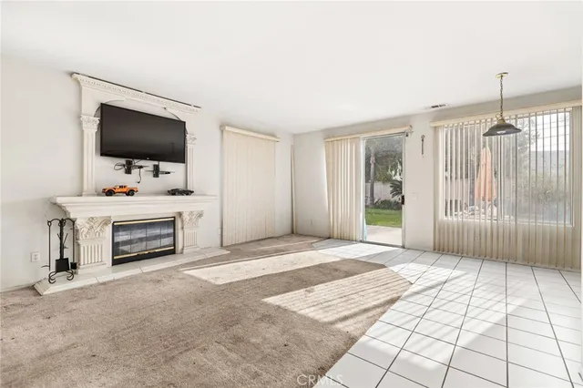 a living room with a flat screen tv and a fireplace