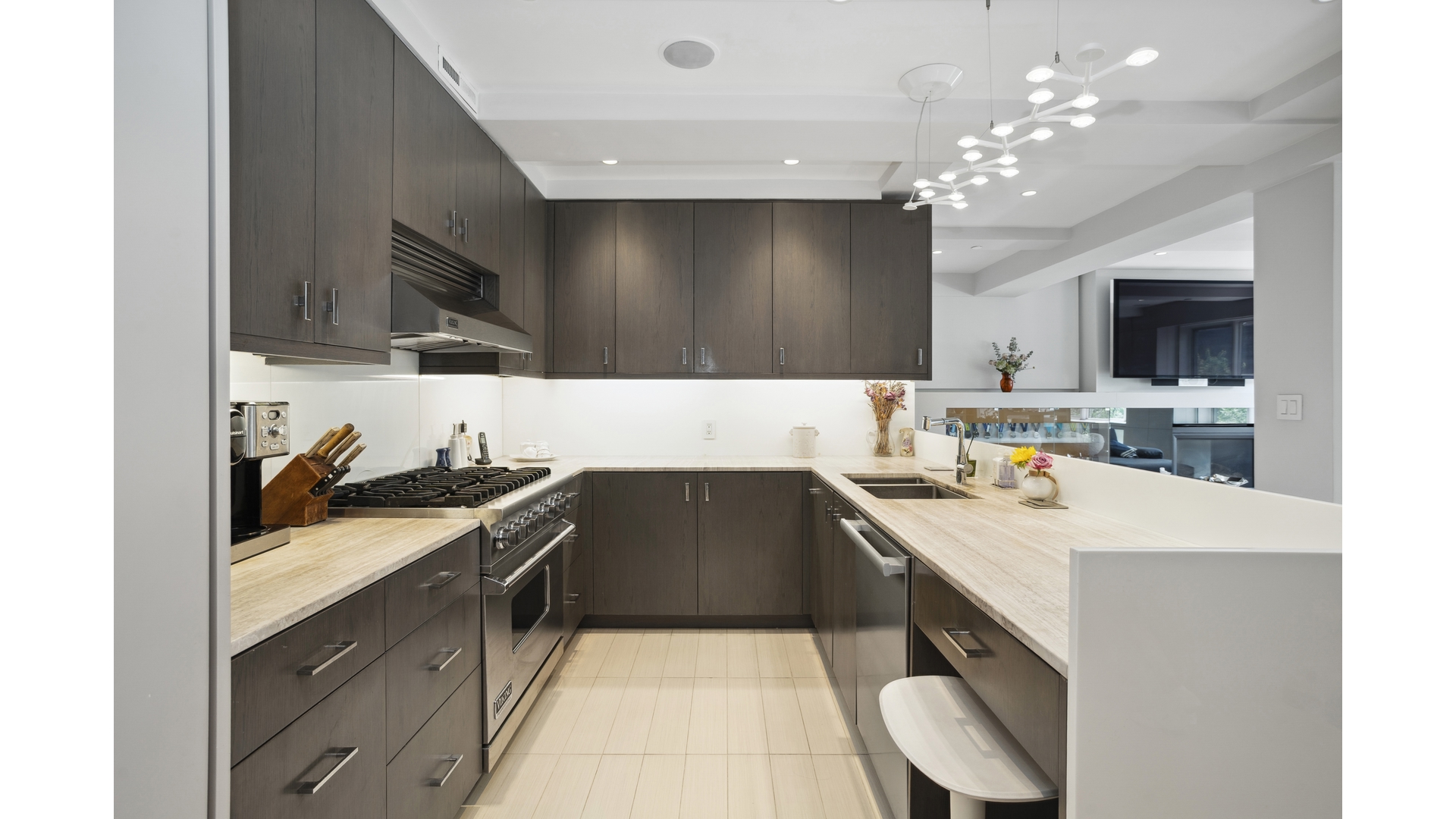435 East 76th Street, Unit 6A Manhattan, NY 10021 - Photo 4 of 13 a kitchen with a sink a stove and chairs